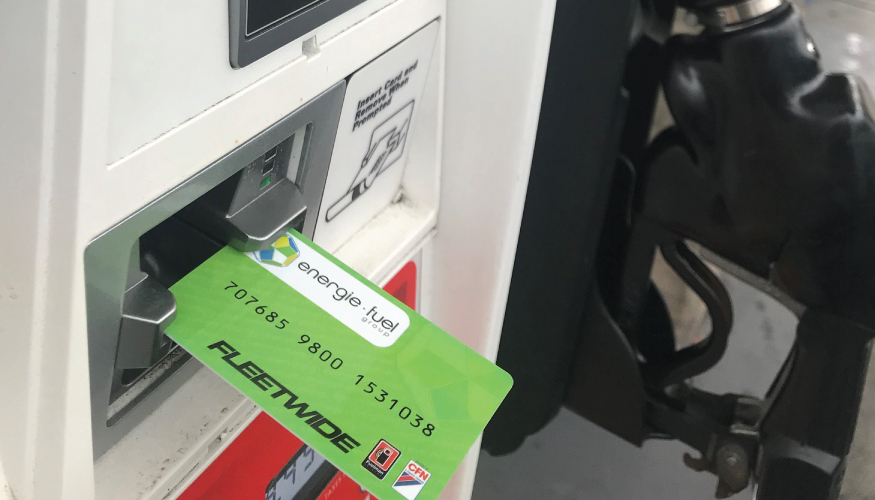 Descriptive text: An Energie Fuel Group fuel card inserted in a card reader of a pump at a gas station.
