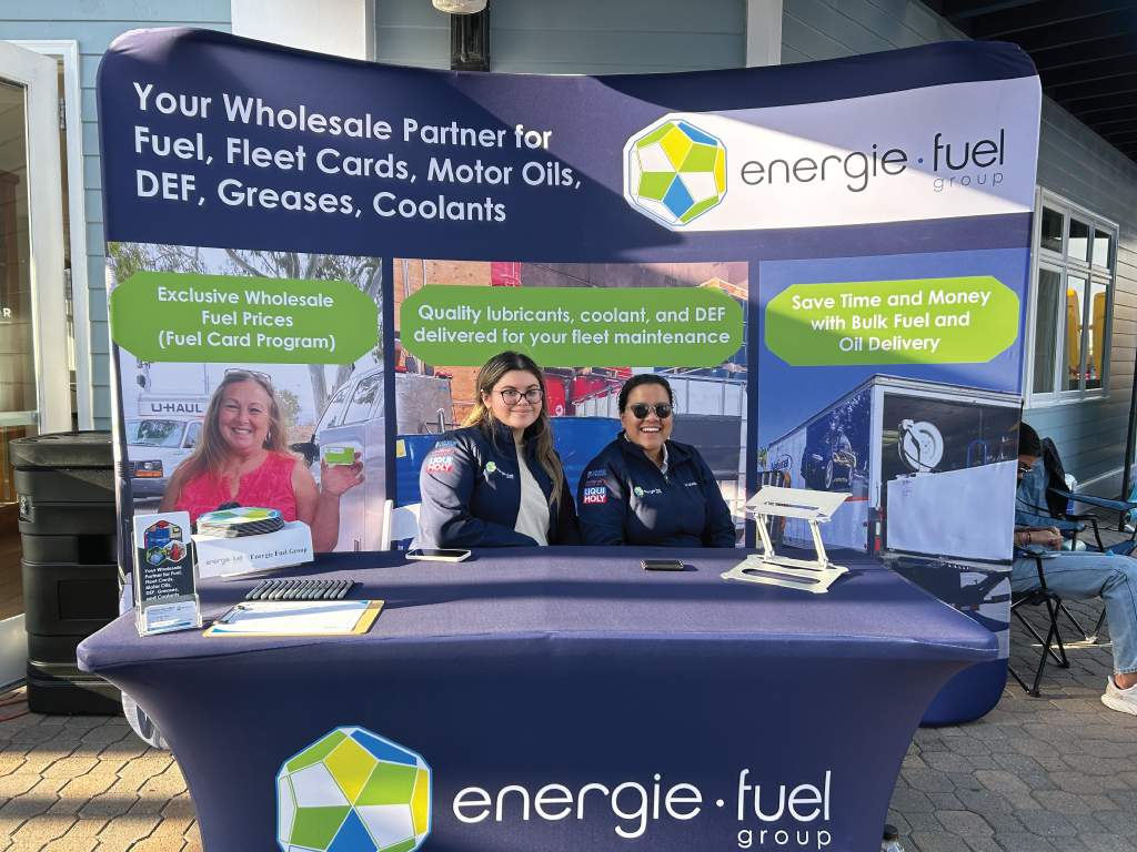 A picture of the energie·fuel team members smiling while tabling at a Business Showcase in California.