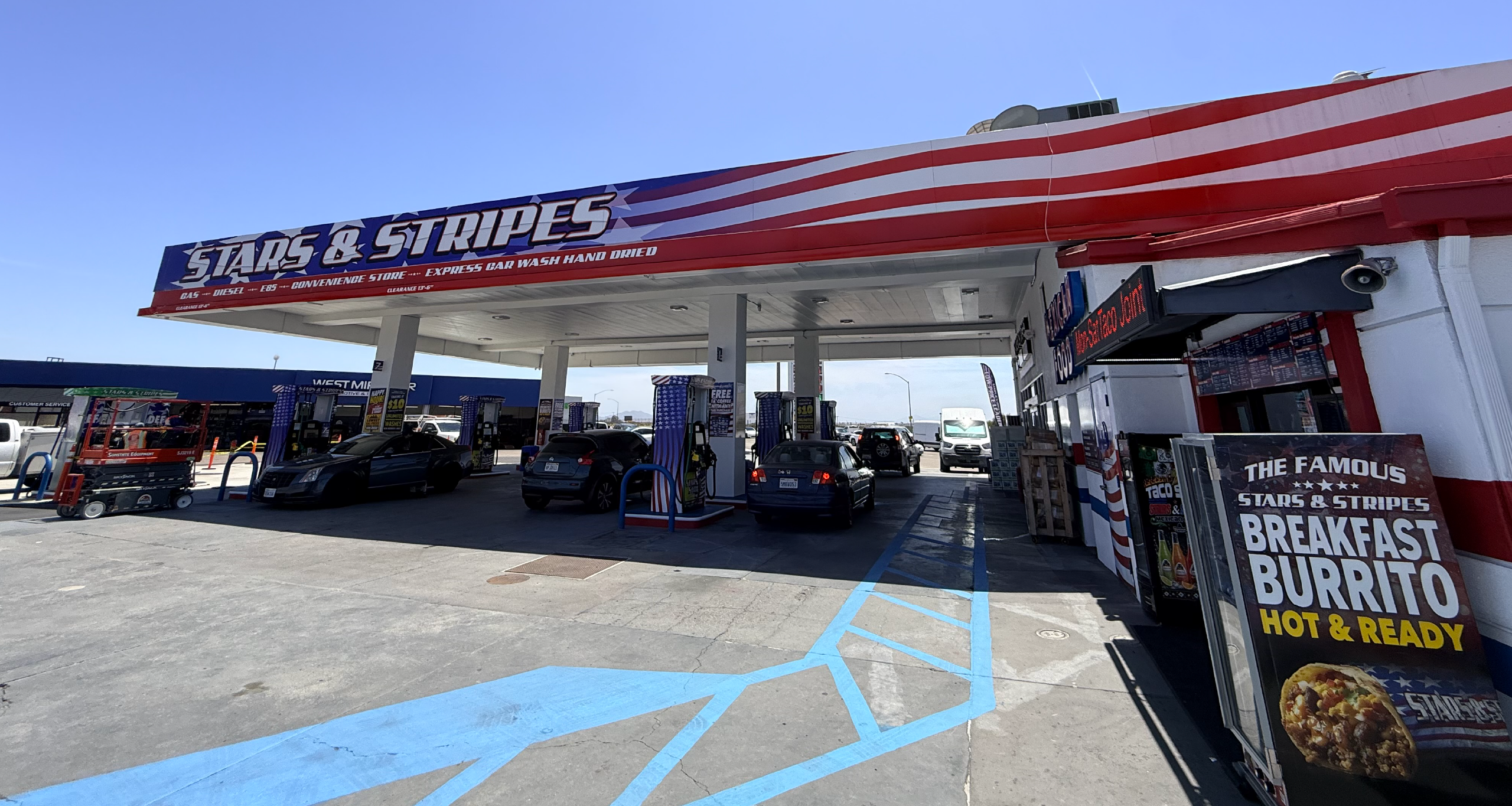 Stars & Stripes Travel Center in Miramar, California, featuring a large fueling canopy serving both commercial trucks and passenger vehicles. A red semi-truck, delivery trucks, and cars are fueling at the station, highlighting a convenient fleet fueling location where Energie Fuel Card users can access wholesale fuel pricing and dependable service.