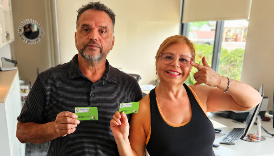 Picture of man and woman company owners holding their Energie Fuel cards.
